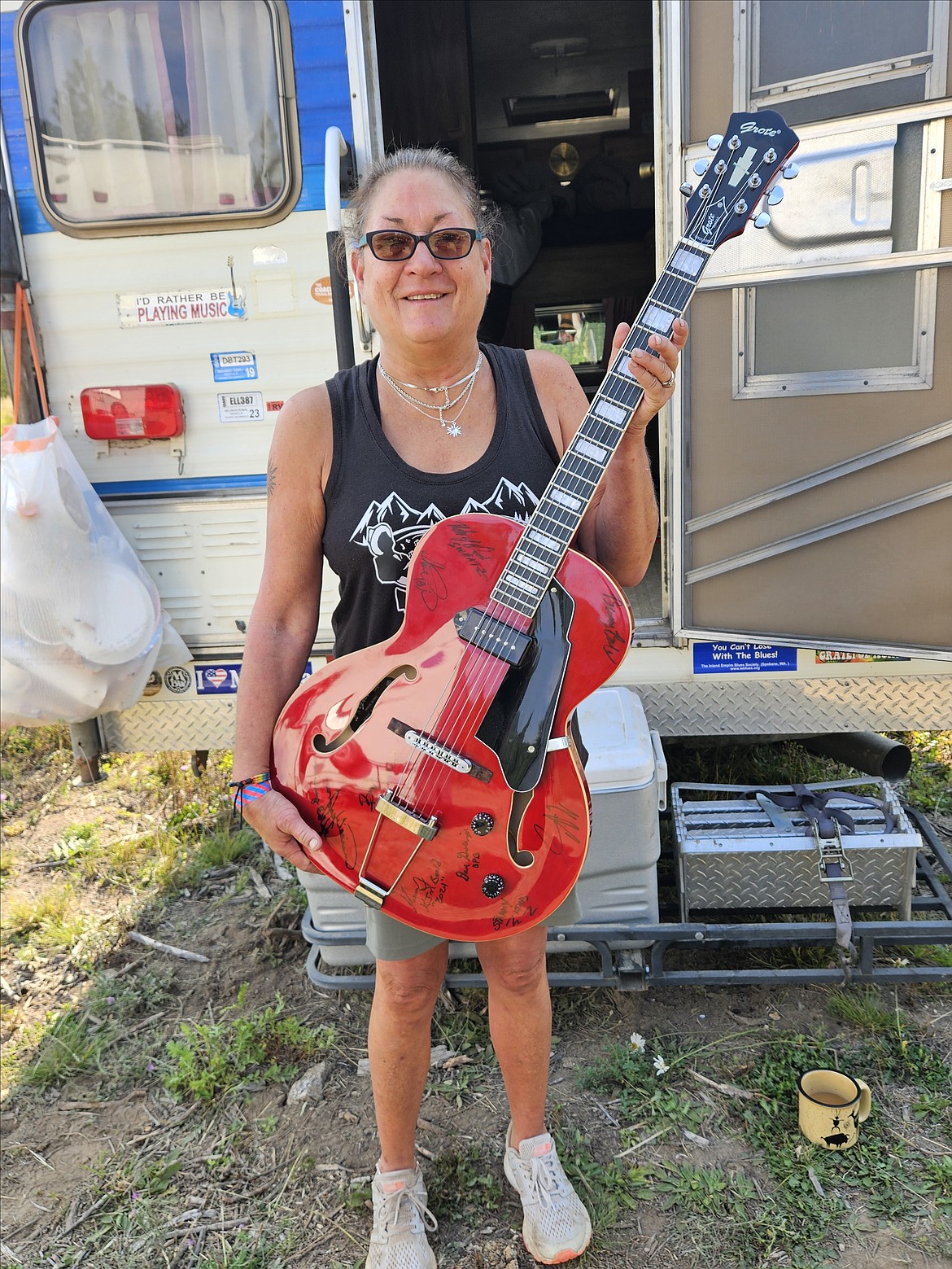 Sheryl Willcox Shreve  displays the signed guitar she won as part of a Panhandle Bluesfest raffle.