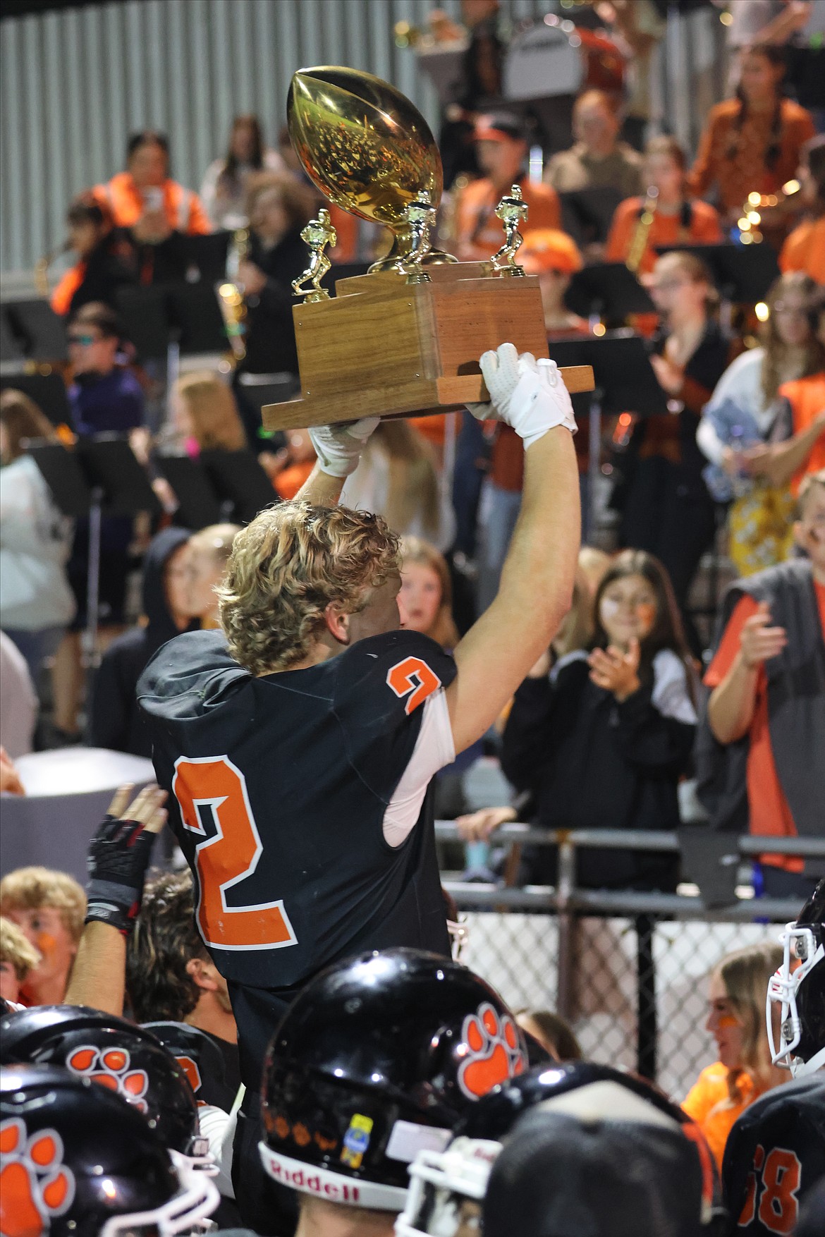 Llandon Ahmann, senior, raises the Battle of the Basin trophy in celebration following the Tigers 33-0 win over rival Quincy. Ahmann, coming off an Athlete of the Week performance against Prosser last week continued his hot ways against Quincy.