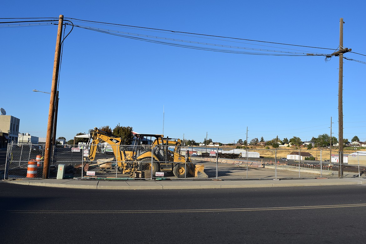 Construction equipment sits in a gated area Wednesday night at the intersection of Division Avenue East and Alder Street NW. That end of the local Amtrak facility is being upgraded to make it more accessible.