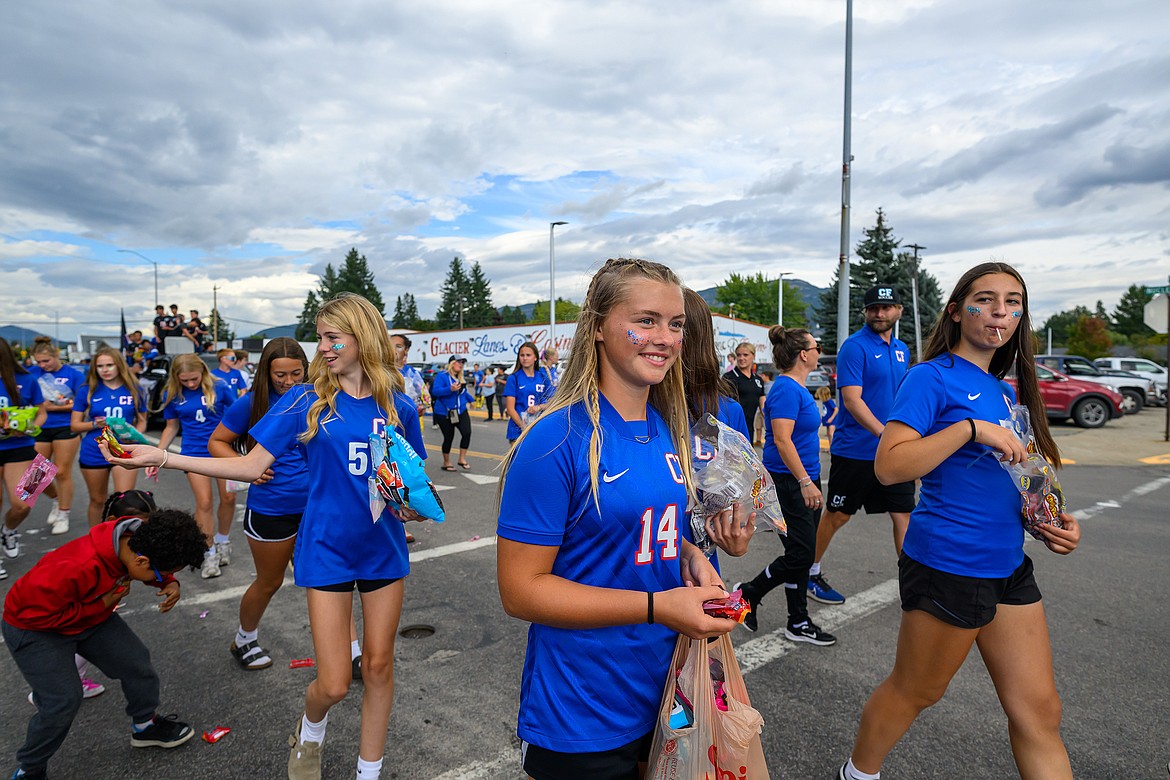 The girls soccer team hands out candy.