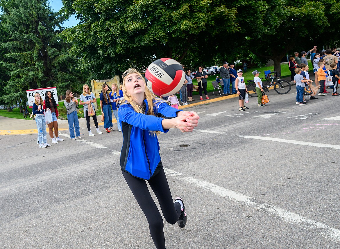 A volleyball player returns serve during the parade.