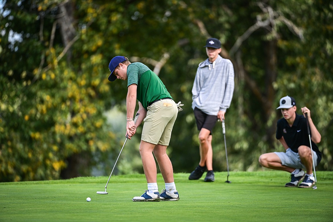 Glacier's Torren Murray putts on the fourth green during the Kalispell Invitational at Buffalo Hill Golf Club on Thursday, Sept. 19. Behind him are Polson's Max Milton and Sentinel's Hudson Goroski. (Casey Kreider/Daily Inter Lake)