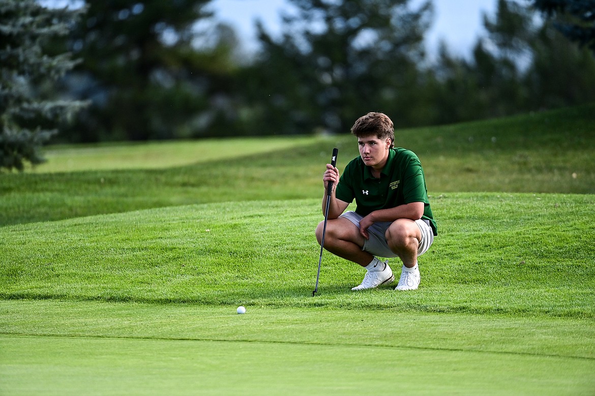 Whitefish's Otto Klein looks over the line on his putt on the third hole during the Kalispell Invitational at Buffalo Hill Golf Club on Thursday, Sept. 19. (Casey Kreider/Daily Inter Lake)