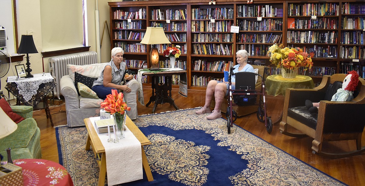 Cindy Sherwood, left, and Virginia Tipple of Wilson Creek hang out in the library at the Hartline Second Hand Mall in the old Hartline School. The two are regular patrons at the shop,they said.