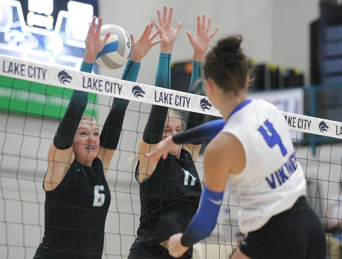 MARK NELKE/Press
Senior Emmery Fuller (6) and senior Josie Hocking (11) of Lake City block a spike attempt by Coeur d'Alene junior Kaylee Paulson (4) on Thursday night at Lake City High.