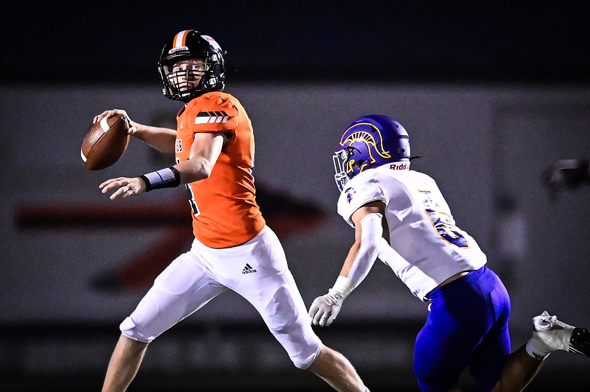 Flathead quarterback Brett Pesola (4) rolls out to pass in the third quarter against Missoula Sentinel at Legends Stadium on Friday, Sept. 20. (Casey Kreider/Daily Inter Lake)