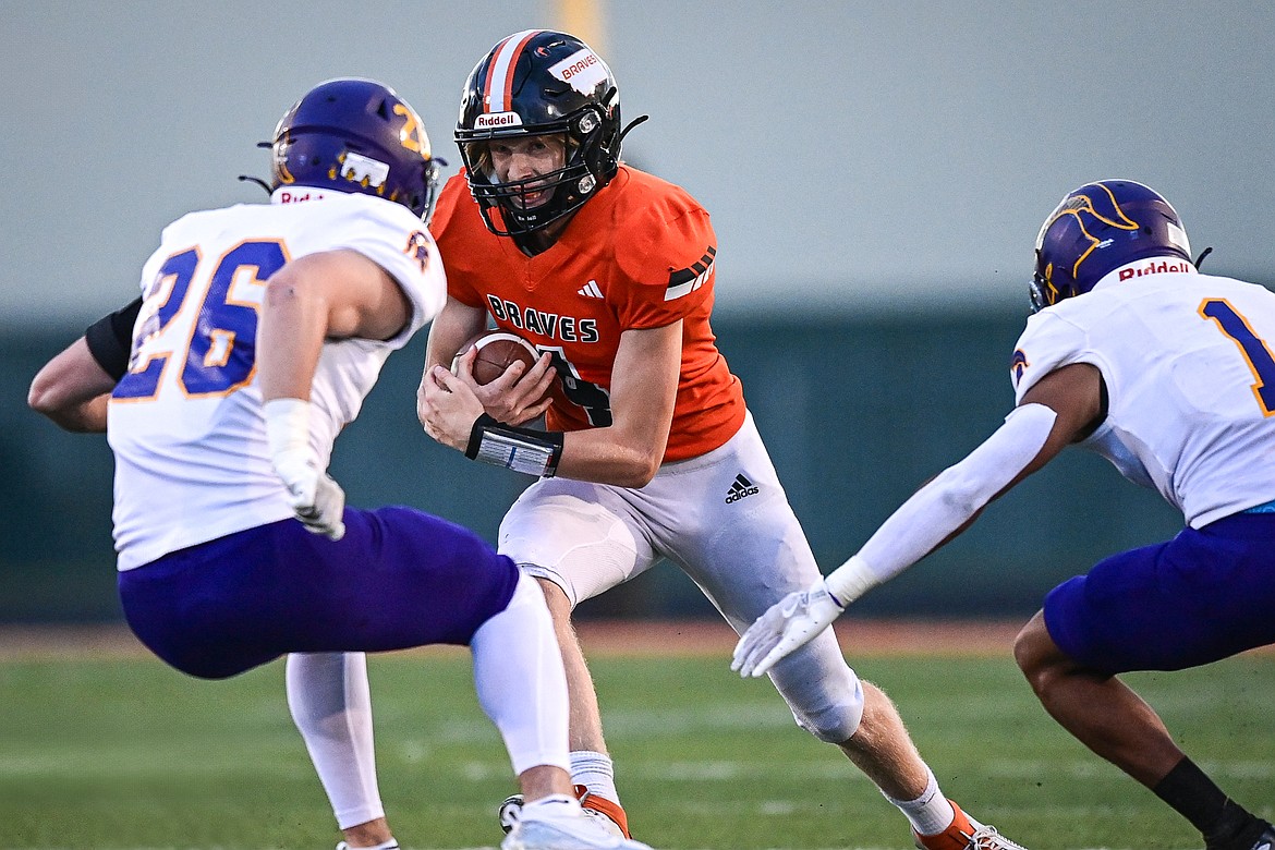 Flathead quarterback Brett Pesola (4) picks up yardage on a run against Missoula Sentinel at Legends Stadium on Friday, Sept. 20. (Casey Kreider/Daily Inter Lake)