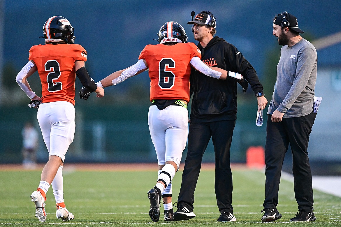 Flathead head coach Caleb Aland celebrates with wide receiver Eli Coopman (6) after Coopman's touchdown reception in the first quarter against Missoula Sentinel at Legends Stadium on Friday, Sept. 20. (Casey Kreider/Daily Inter Lake)