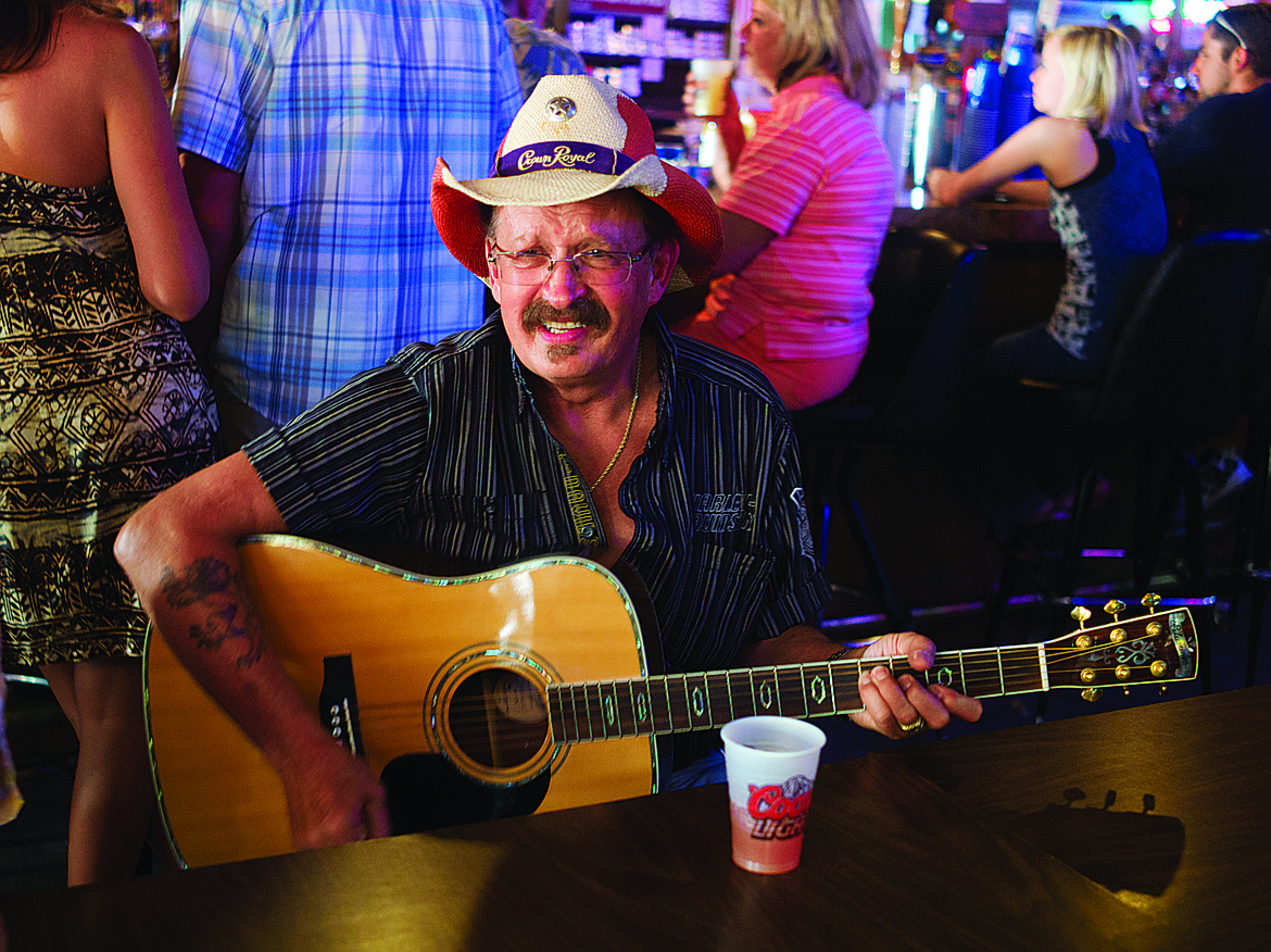 A musician plays guitar at the Columbia Bar in Columbia Falls during a past Heritage Days performance. (Hungry Horse News FILE)