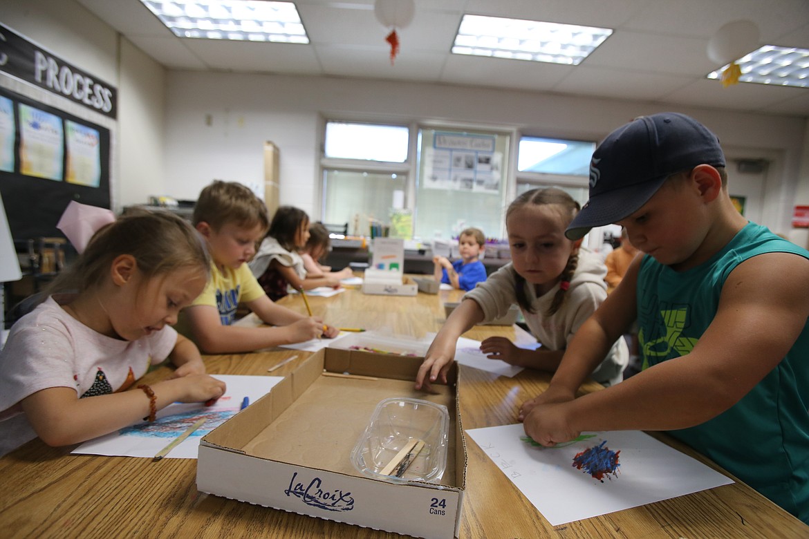 From left, Eleanna Stearns-Van Horn, Emry Fisher, Leona Davis and Beck Bridges enjoy exploring art with oil pastels Wednesday at Fernan STEM Academy. Their teacher, Leatha Morgan, is the Idaho Art Education Association's Elementary Educator of the Year.