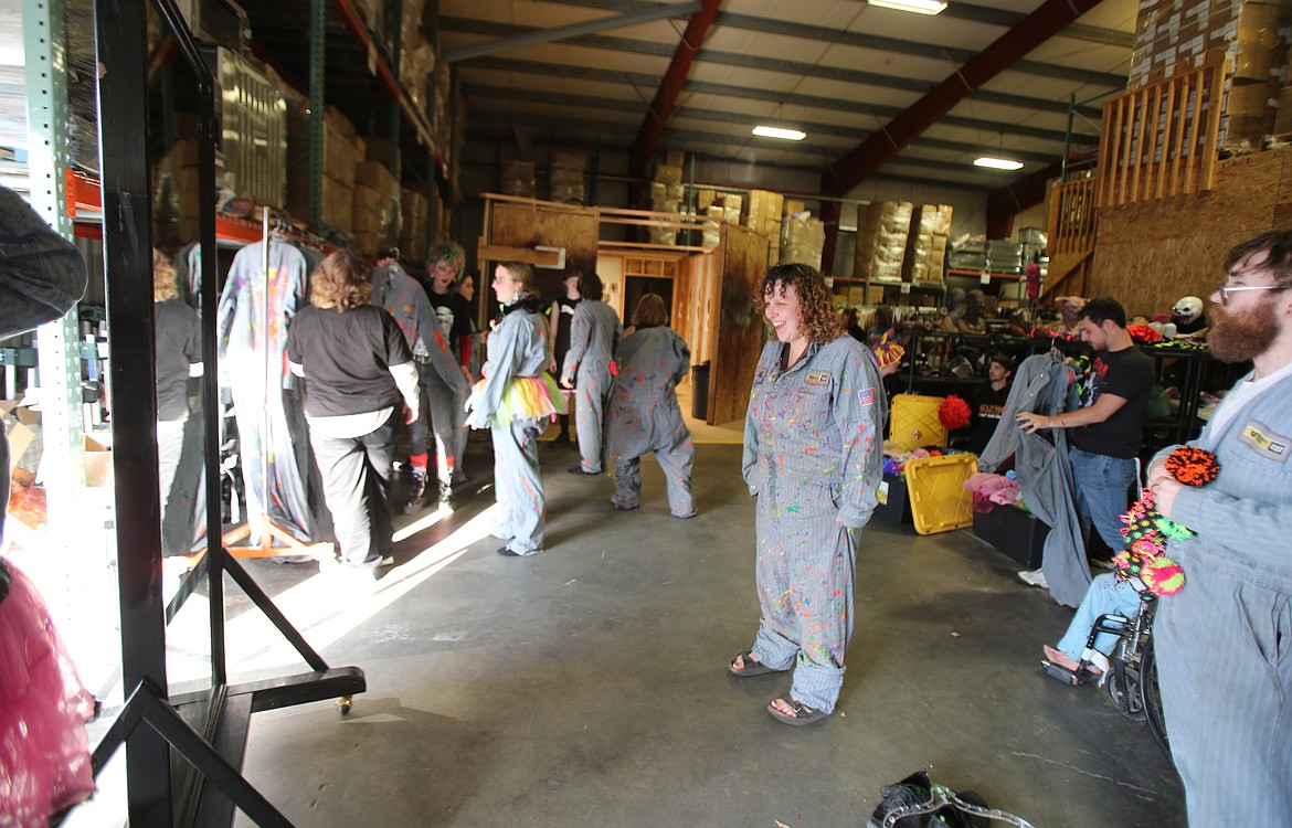 Jess Frazier admires her 3Dementia clown jumpsuit in the Scarywood costume warehouse.