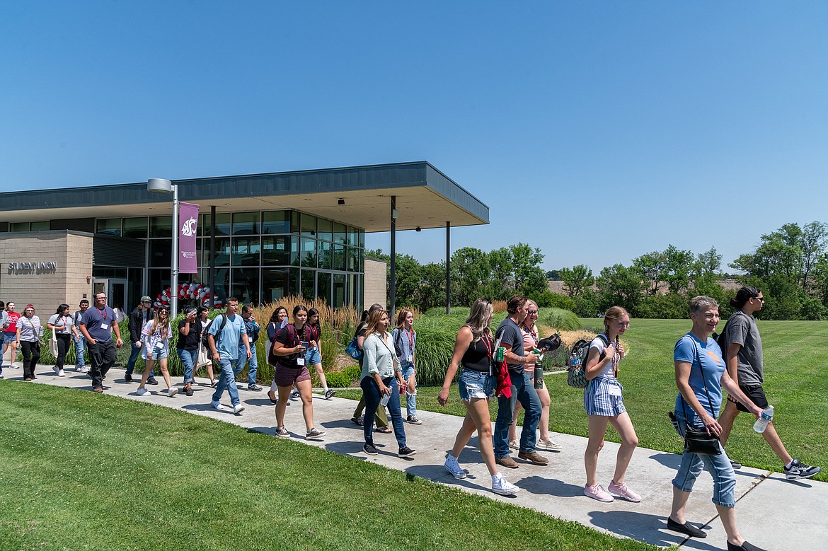 Students walk by the WSU Student Union building at the Tri-Cities campus. This year's freshman class is the largest the campus has ever had.