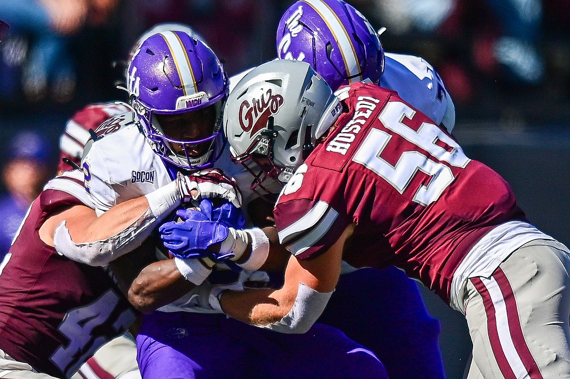 Grizzlies linebackers Riley Meyer (42) and Garrett Hustedt (56) tackle Western Carolina running back Branson Adams (2) in the second quarter at Washington-Grizzly Stadium on Saturday, Sept. 21. (Casey Kreider/Daily Inter Lake)