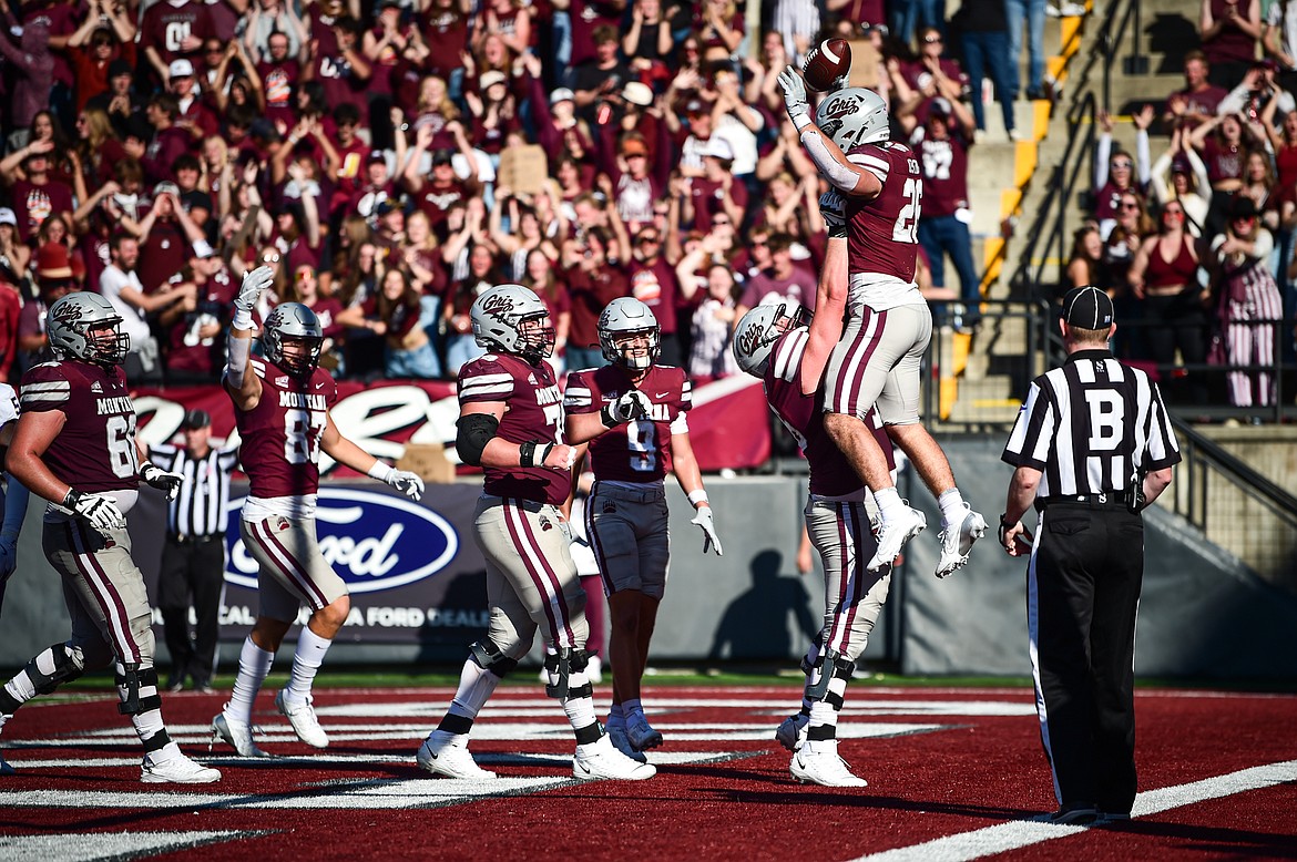 Grizzlies running back Nick Ostmo (26) celebrates in the end zone with teammates after a 12-yard touchdown run in the fourth quarter against Western Carolina at Washington-Grizzly Stadium on Saturday, Sept. 21. (Casey Kreider/Daily Inter Lake)