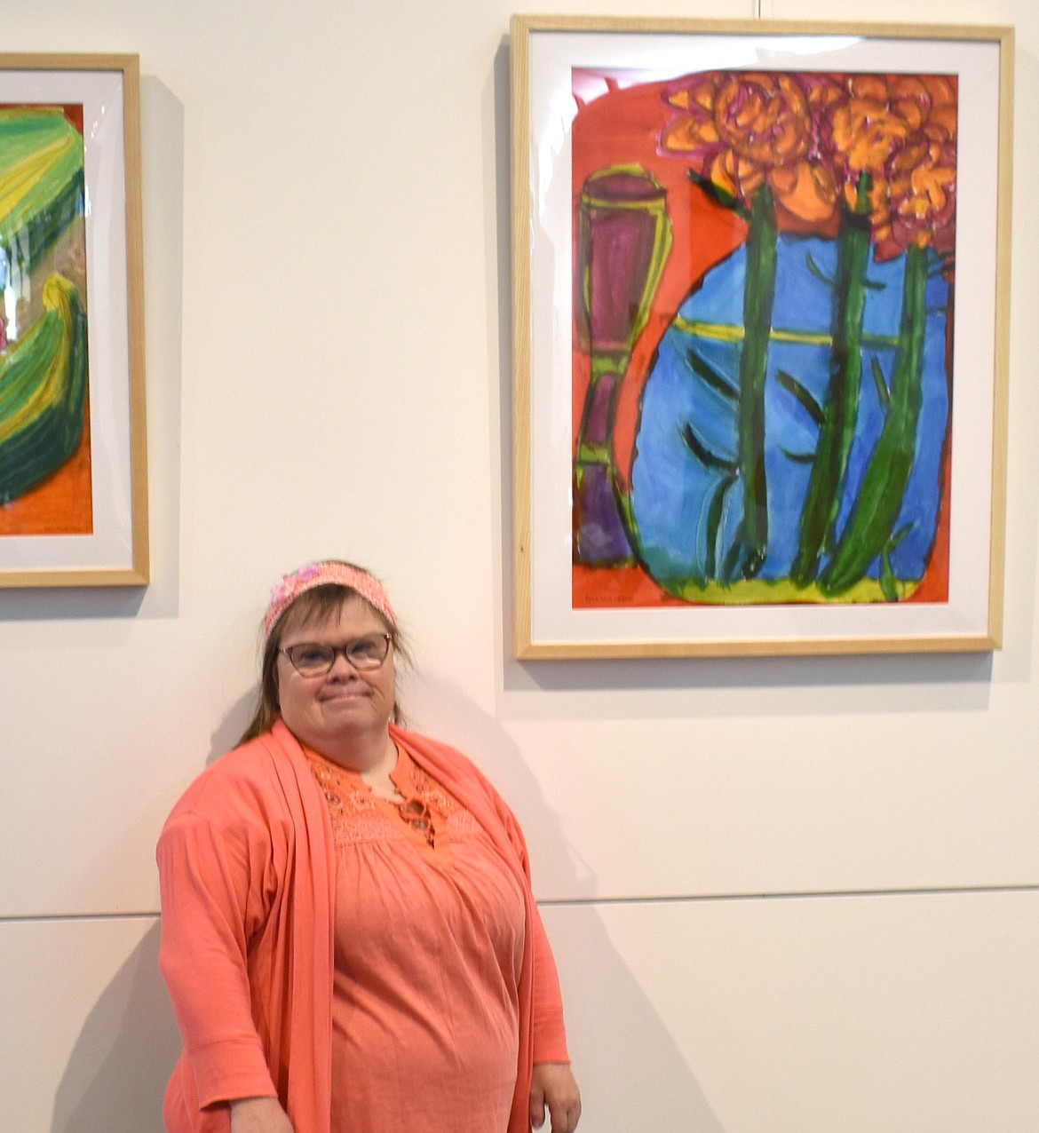 Painter Beth Anna Margolis stands with one of her paintings at the Moses Lake Museum & Art Center in May. Margolis, who has Down syndrome, inspired the theme “Share your Gifts” for this year’s Buddy Walk Saturday.