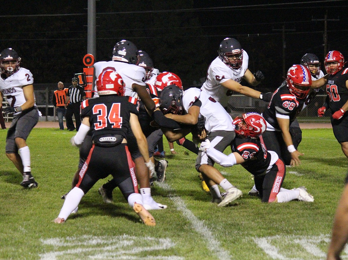 The Othello defense swarms a Grandview ball carrier in Friday’s win. The Huskies shut out the Greyhounds in Friday’s 41-0 win.