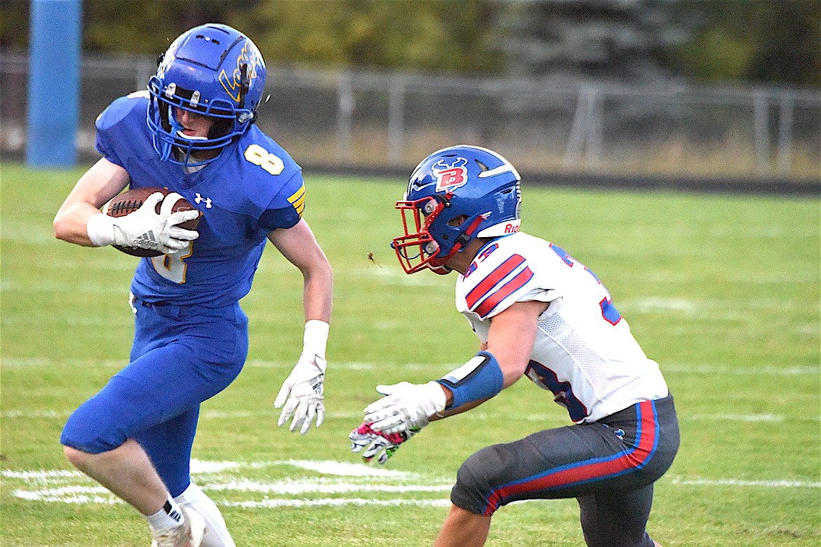 Libby's Ryan Beagle (8) evades a Bigfork defender after catching a pass Friday, Sept. 20, 2024, against Bigfork. (Scott Shindledecker/The Western News)