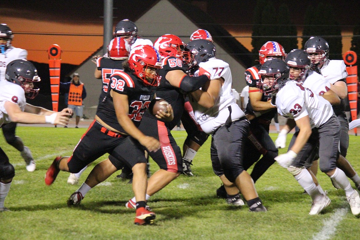 Othello senior Jordan DeLeon (32) turns the corner behind the block from senior Mason Perez (50) in Othello's win Friday.  DeLeon scored two rushing touchdowns in the win, while Perez scored on defense on a fumble returned for a touchdown in the win over Grandview.