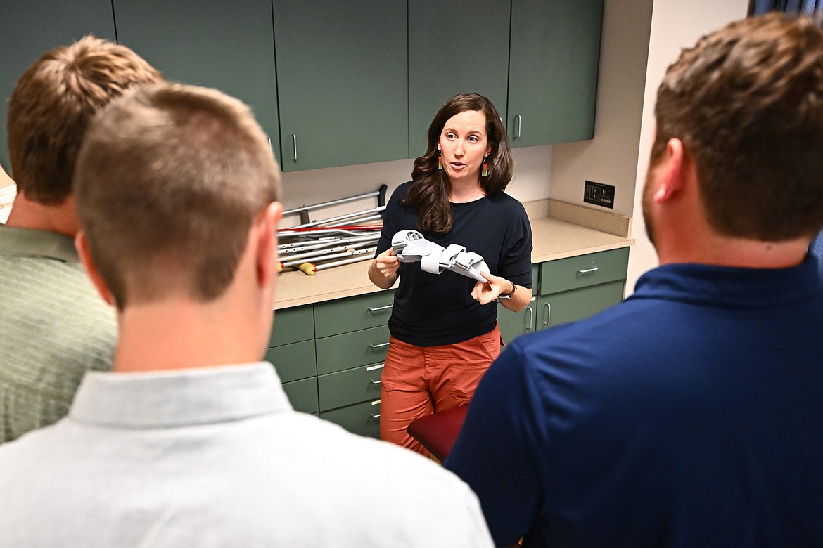 Assistant Professor Janna Smith talks with University of Montana students recently about upper extremity orthotics and slings. (UM photo by Ryan Brennecke)