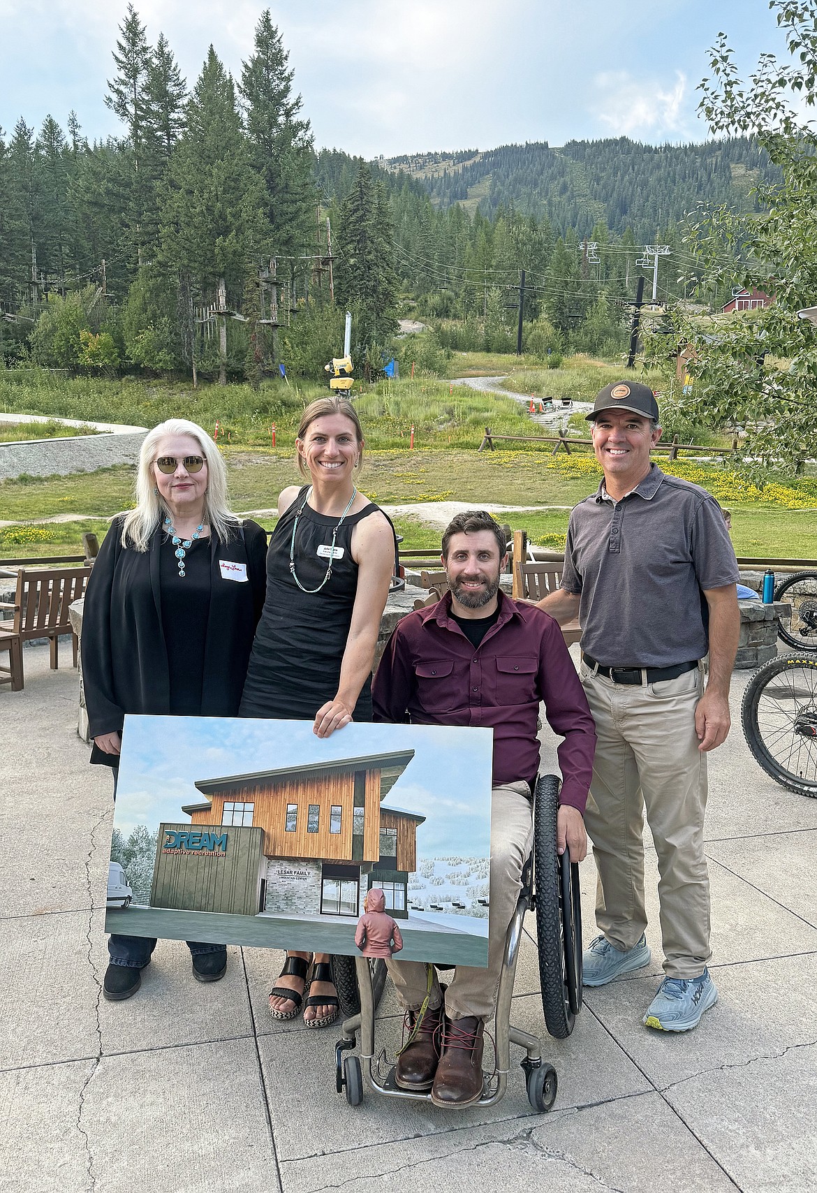 Sherry Lesar, Julie Tickle, Lucas Stacy and Nick Polumbus with a rendering of the new DREAM home base at the lead gift ceremony on the patio of the base lodge at Whitefish Mountain Resort last month. (Photo provided)