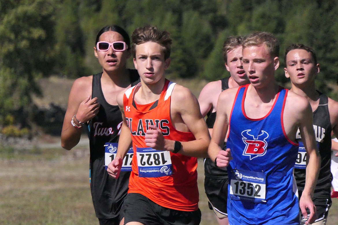 Plains runner Kalem Ercanbrack (orange jersey) runs amid a pack of runners during the Thompson Falls Invitational meet this past Saturday. (Chuck Bandel/VP-MI)