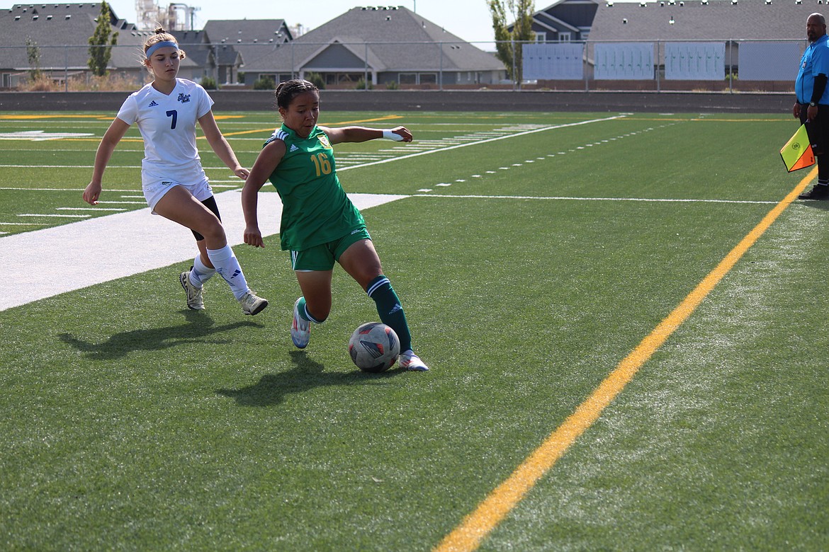 Lizbeth Diaz (16), Quincy, works to keep the ball in play against Lakeside Saturday.