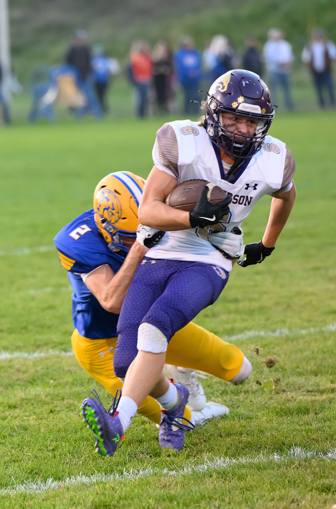 Thompson Falls senior Ian Myers (2) latches onto a Jefferson running back during their game Friday night at Previs Field. (Phot by Tracy Scott)