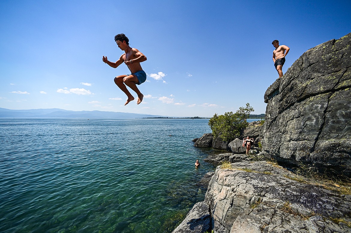 Safin Zaslansky plunges into Flathead Lake from the cliffs at the Wayfarers unit of Flathead Lake State Park in Bigfork on Wednesday, July 10. (Casey Kreider/Daily Inter Lake)