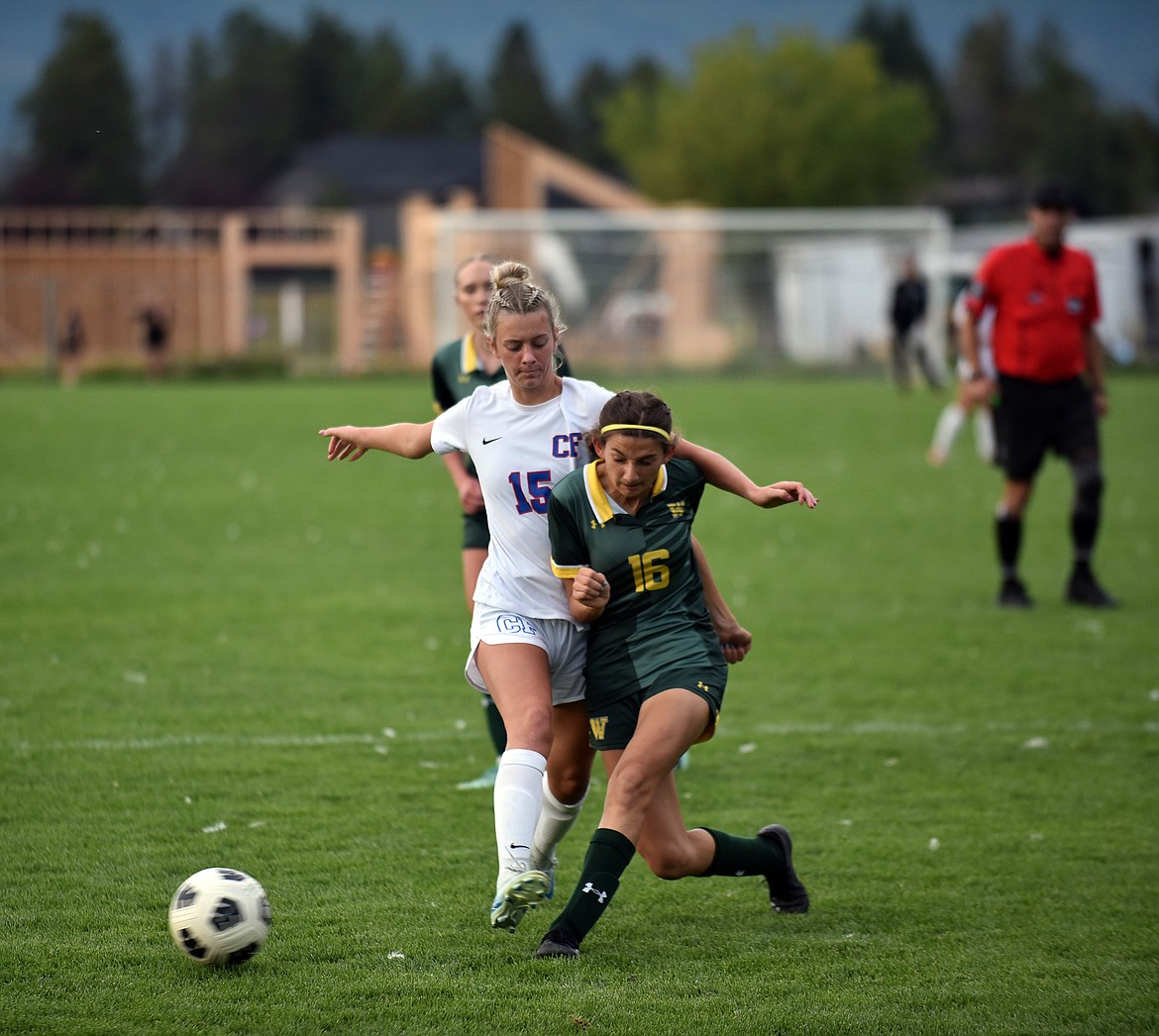 Bulldog freshman Gracie Sliman dribbles past Wildkat Taryn Borgen at the crosstown game last week. (Julie Engler/Whitefish Pilot)