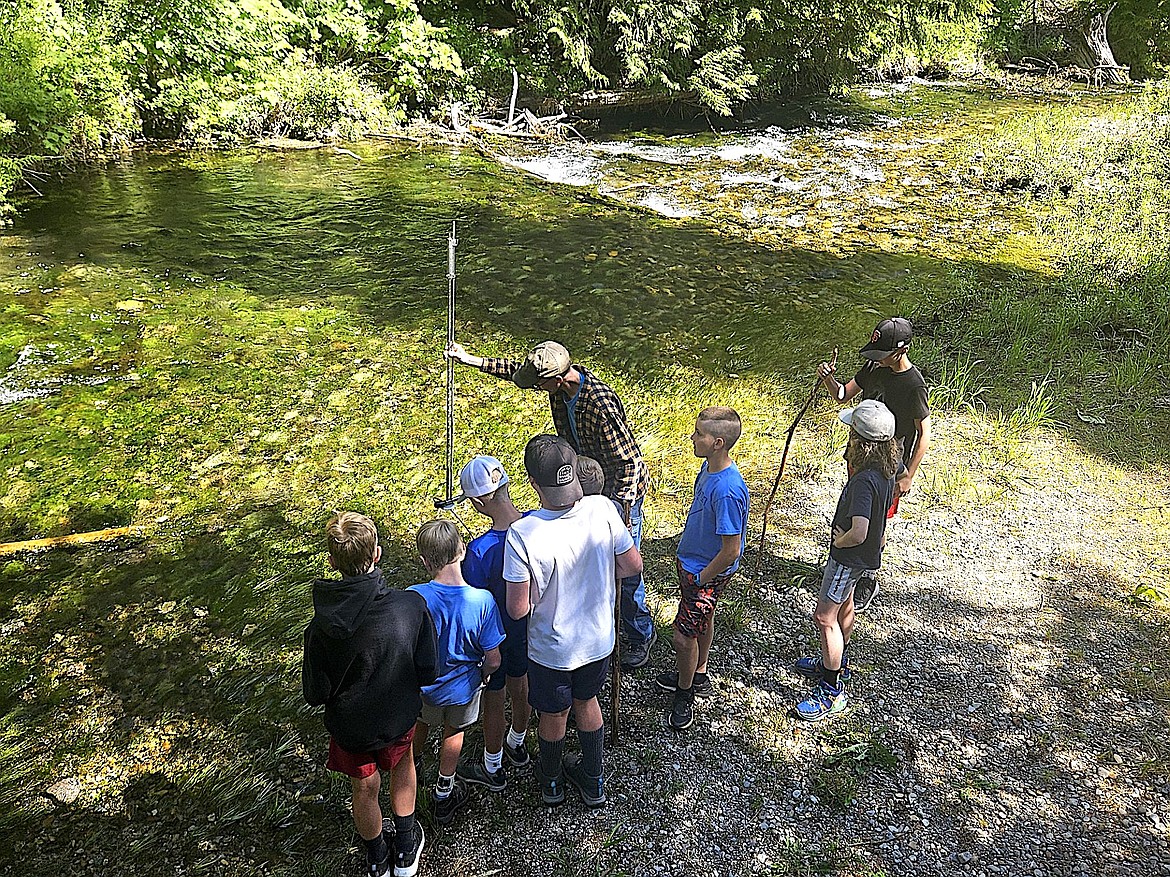 Kootenai National Forest’s Hydrologist Ben Hegler teaches a group of kids in the Kootenai Outdoor Adventure Program about hydrology in June at Ross Creek. (Photo courtesy Bill Moe)