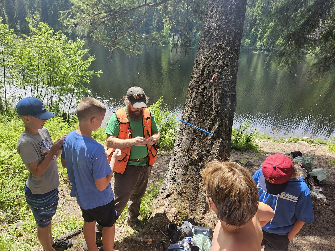 Kootenai National Forest’s Ed Sedler teaches a group of kids in the Kootenai Outdoor Adventure Program about forestry in June at Ross Creek. (Photo courtesy Bill Moe)