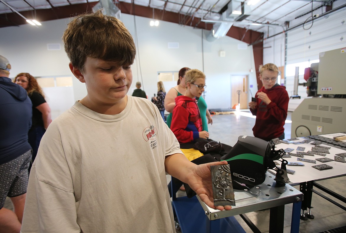 Eighth grader Aiden Hanning displays a piece of metal he welded at school during the career-technical education showcase Tuesday at Elevate Academy North in Post Falls.