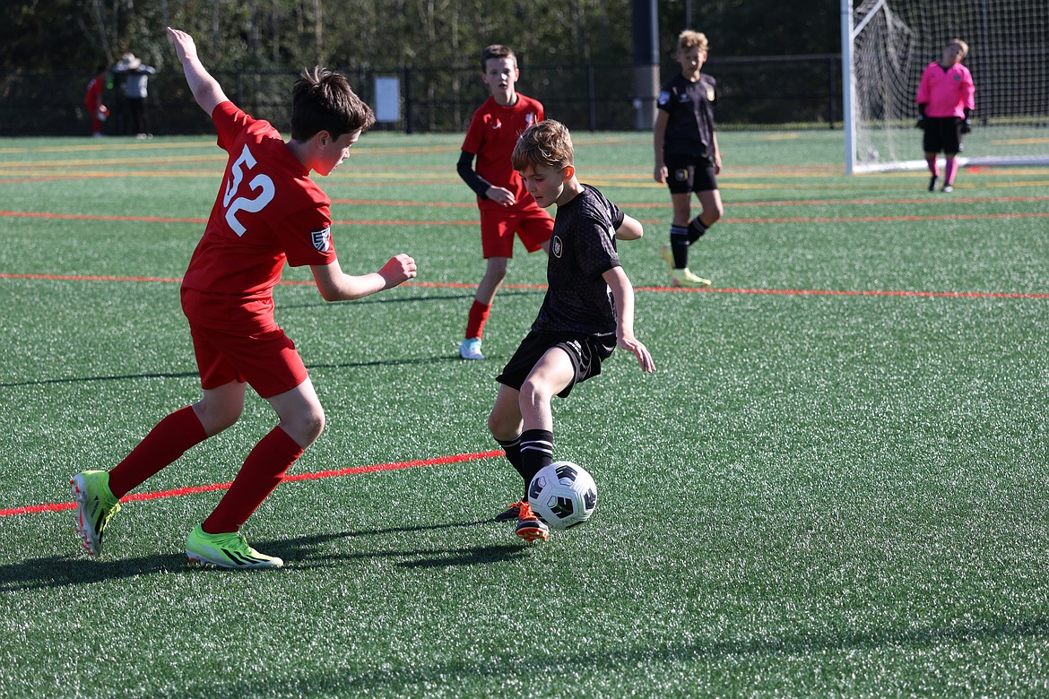 Courtesy photo
The Sting SC 2013 Boys Academy soccer played two games in Seattle last weekend, losing to the Seattle Celtics 3-0, then beating Liverpool International 2-1 with goals from Luke Baune and Levi Pooler. Pictured in the black jersey is Nolan Bode of the Sting.