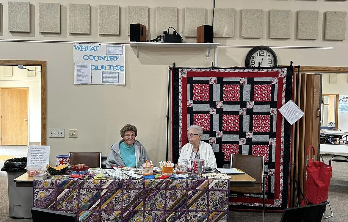 Sharon Andersen, left, and Helen Ladwig of the Wheat Country Quilters sell quilt raffle tickets at last year’s Almira Country Fair. This year’s event is Saturday.