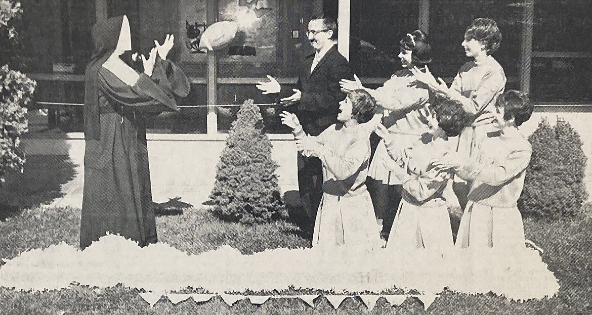 In 1964, Sister Avellina, the IHM Academy principal, tossed a football to coach Gene Boyle and cheerleaders, kneeling, from left, Jane Lauf, Kathleen McMurray and Barb Whiteley, and, standing, Linda Larsen and Ann Matson.