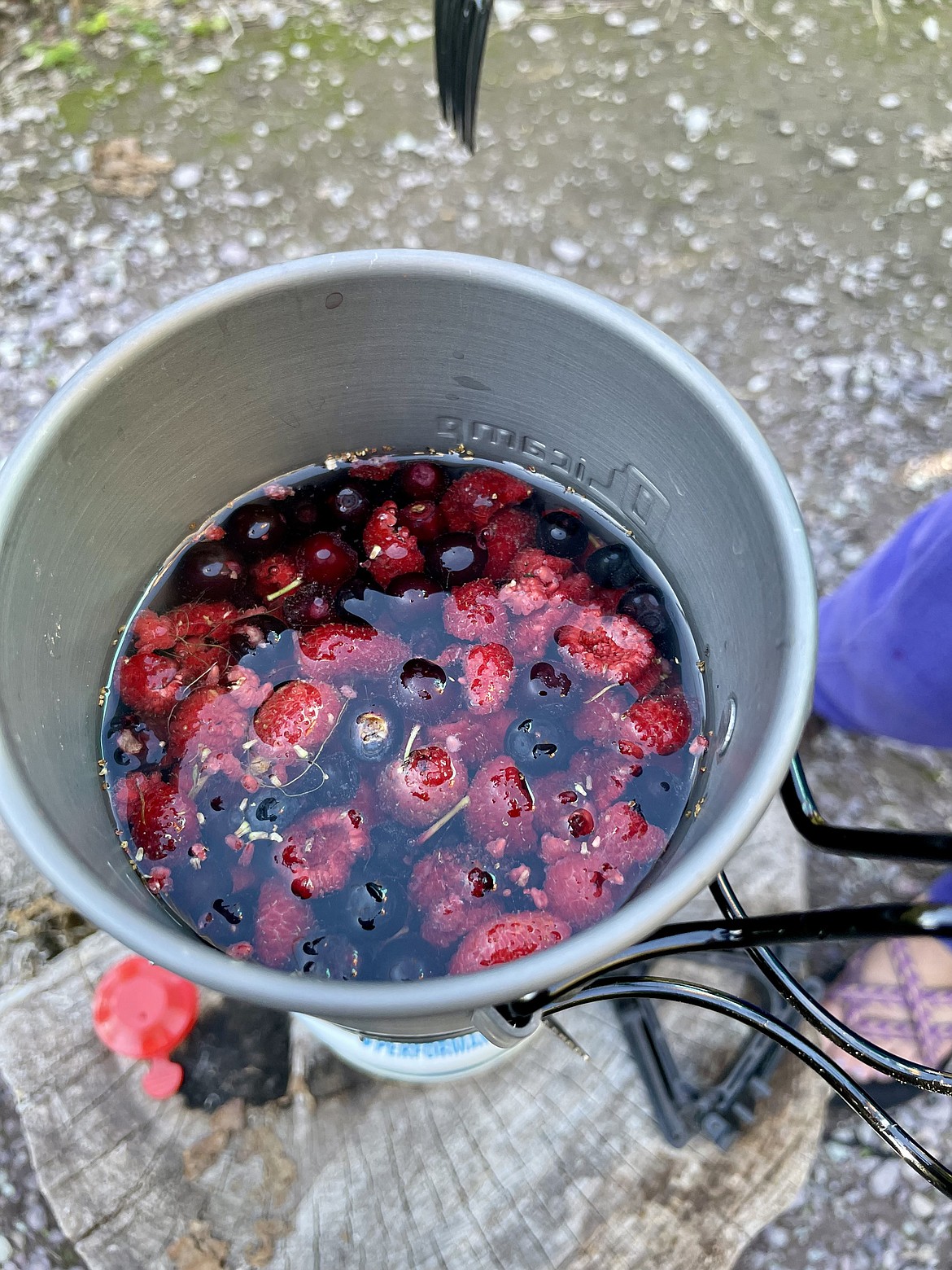 A brew of huckleberries and thimbleberries is cooked on a camp stove at Snyder Lake Campground in Glacier National Park on Saturday, Sept. 21, 2024. (Matt Baldwin/Daily Inter Lake)