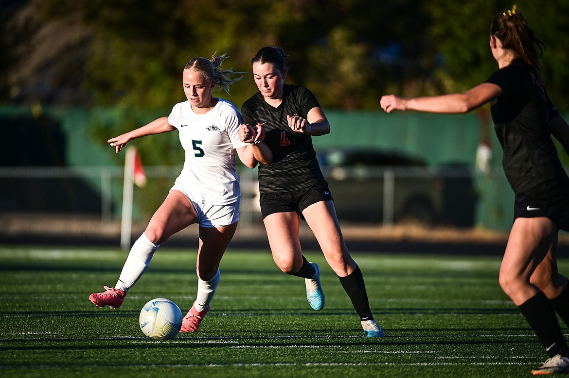 Glacier's Neve Travis (5) and Flathead's Azalea Bailey (4) battle for possession at Legends Stadium on Thursday, Sept. 26. (Casey Kreider/Daily Inter Lake)