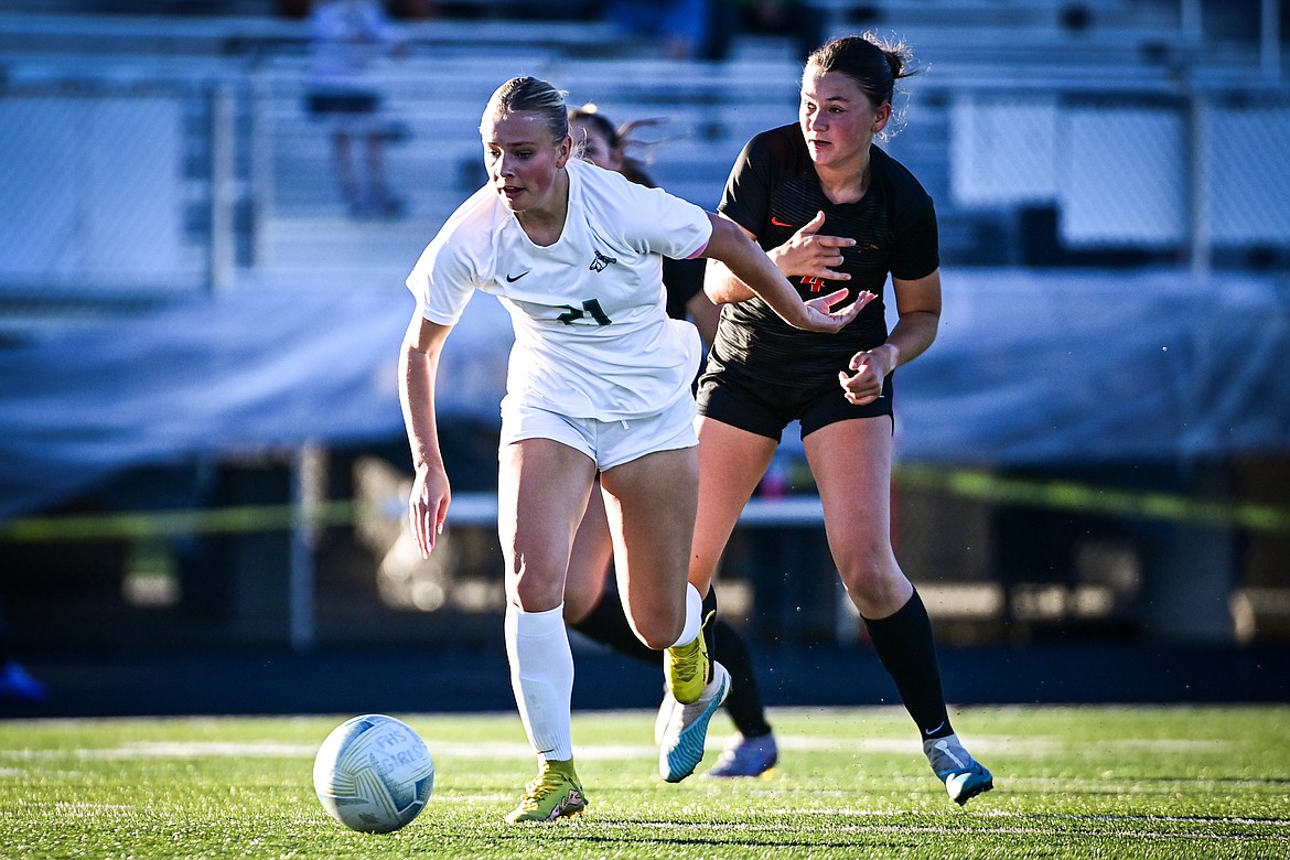 Glacier's Emmery Schmidt (21) pushes the ball upfield in the first half against Flathead at Legends Stadium on Thursday, Sept. 26. (Casey Kreider/Daily Inter Lake)