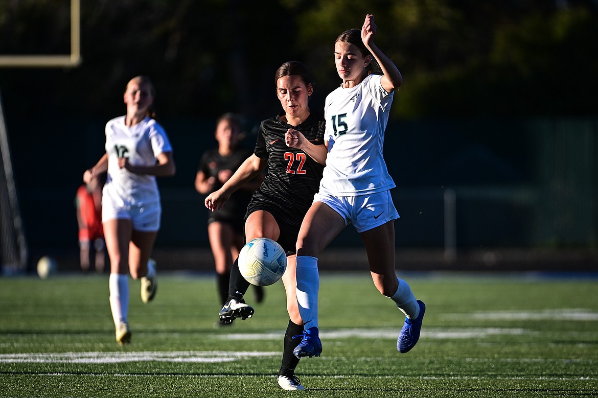 Flathead's Camas Bushnell (22) and Glacier's Addison Brisendine (15) battle for a ball in the first half at Legends Stadium on Thursday, Sept. 26. (Casey Kreider/Daily Inter Lake)