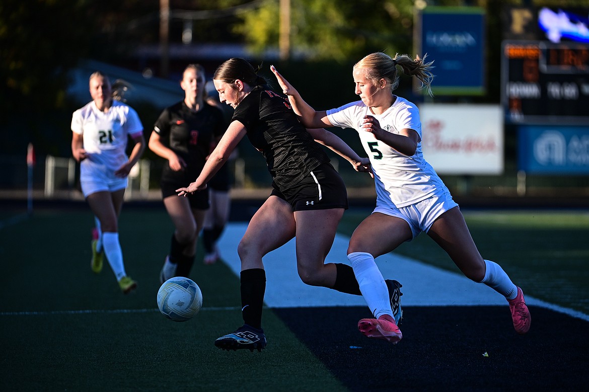 Flathead's Chloe Baker (23) and Glacier's Neve Travis (5) battle for a ball in the first half at Legends Stadium on Thursday, Sept. 26. (Casey Kreider/Daily Inter Lake)