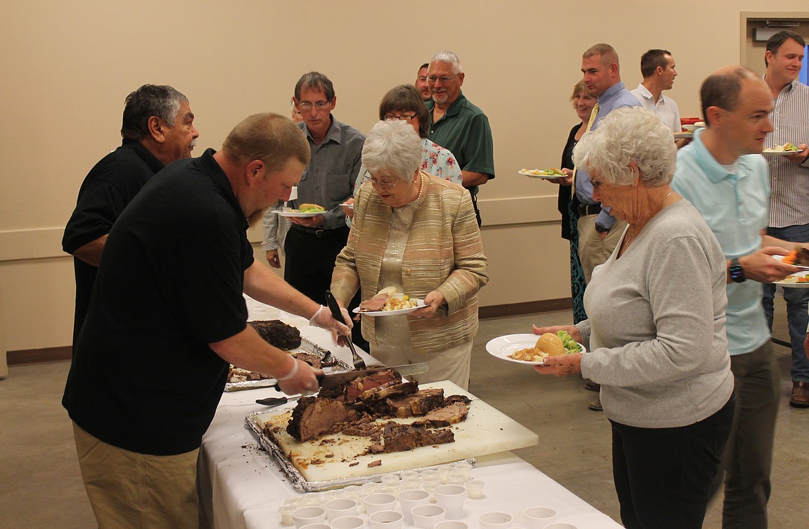 Top Gun Catering staff serve up prime rib at a previous Crossroads Resource Center fundraiser banquet. This year’s event is Oct. 12.