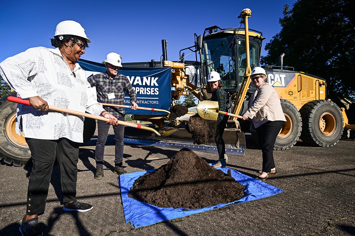 Samaritan House resident Joan Corbin, executive director Chris Krager, board president Danielle Maiden and campaign chair and president and CEO of the Kalispell Chamber Lorraine Clarno, raise shovels of dirt during a groundbreaking ceremony for Samaritan House's expansion project on Thursday, Sept. 26. (Casey Kreider/Daily Inter Lake)