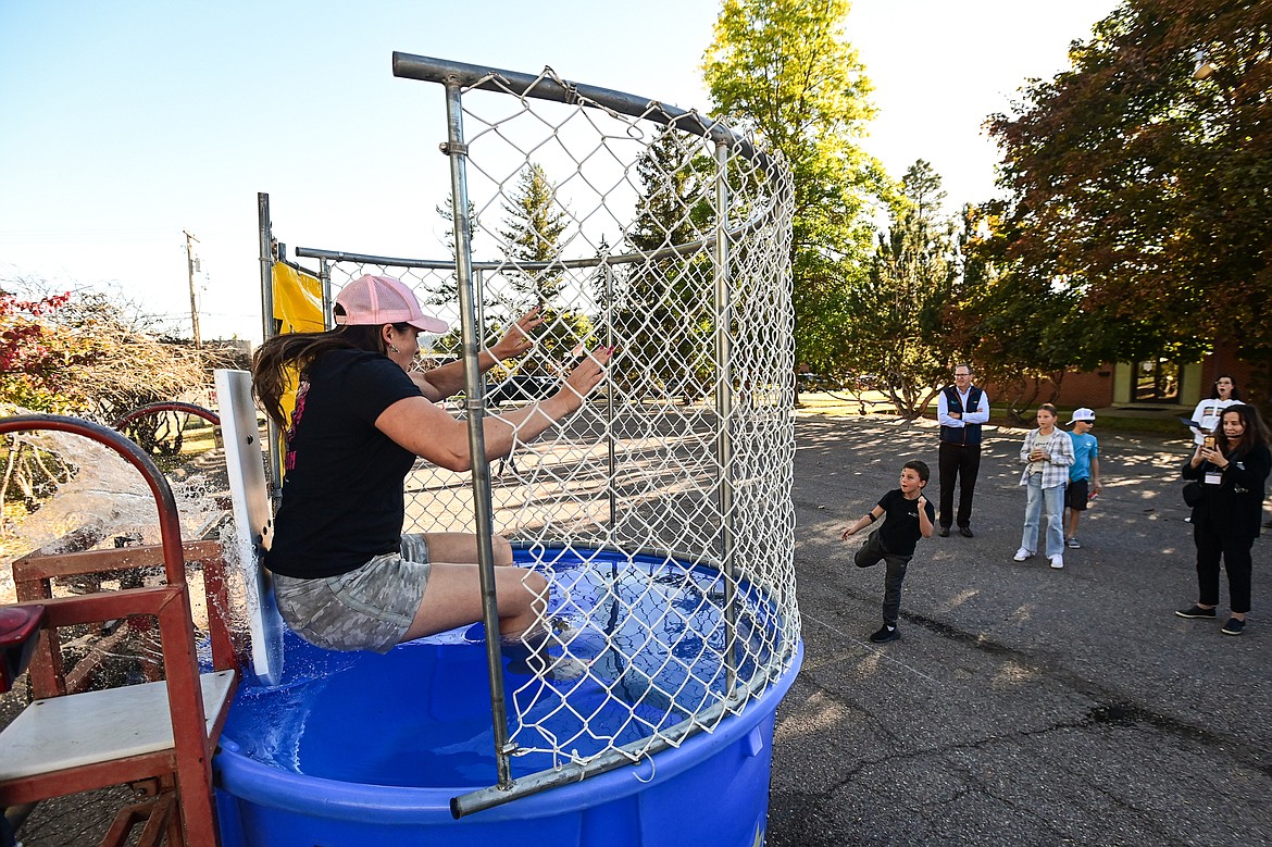 Rep. Courtenay Sprunger splashes into the dunk tank during a groundbreaking ceremony for Samaritan House's expansion project on Thursday, Sept. 26. (Casey Kreider/Daily Inter Lake)