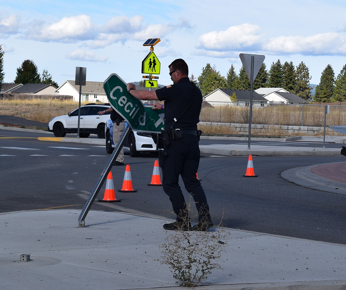 Several road signs were damaged after a vehicle was driven into the median of the Cecil Road and Poleline Avenue roundabout Thursday morning.