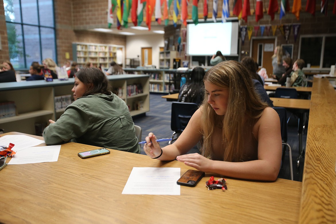 Sophomore Payton Goodwin fills out some paperwork Thursday as she prepares to be a student coach through Growing the STEM, a nonprofit that offers free student-led activities and programming to generate excitement and build confidence around science, technology, engineering and math.