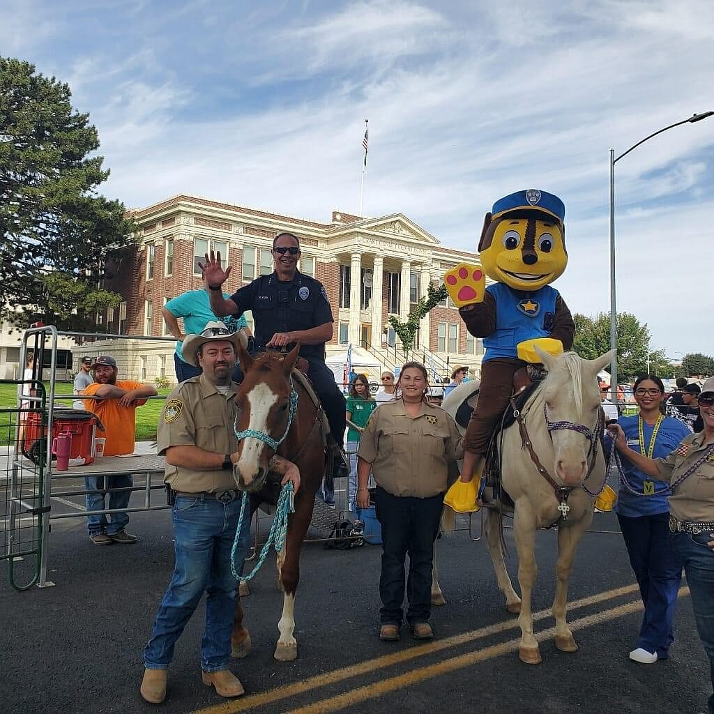 Ephrata Police Department Chief Erik Koch and Chase from Paw Patrol ride horses with the Grant County Mounted Posse at the Autism Awareness Walk.