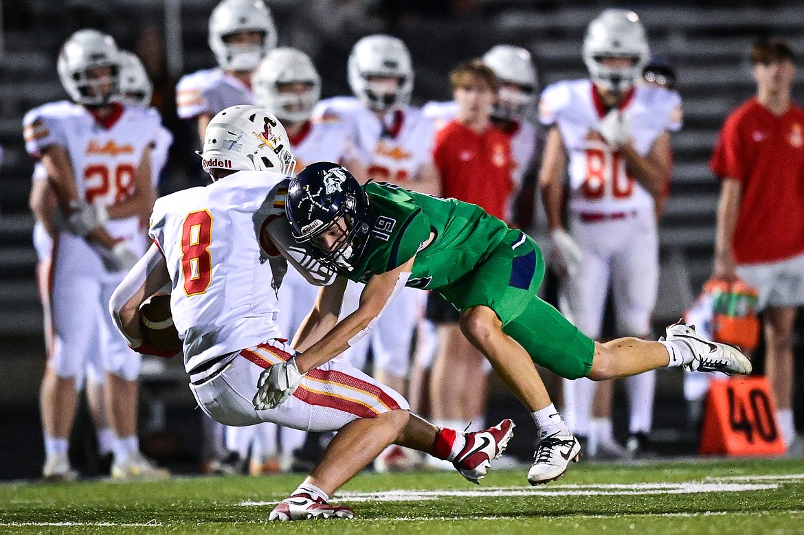 Glacier defensive back Easton Kauffman (19) tackles Missoula Hellgate wide receiver Cole Zeigler (8) in the second quarter at Legends Stadium on Friday, Sept. 27. (Casey Kreider/Daily Inter Lake)