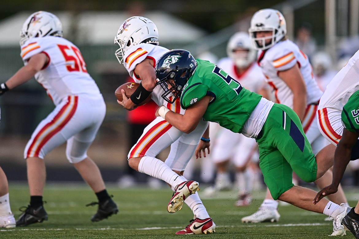 Glacier defensive lineman Wayne Cox (52) sacks Missoula Hellgate quarterback Vince Paffhausen (7) in the first quarter at Legends Stadium on Friday, Sept. 27. (Casey Kreider/Daily Inter Lake)