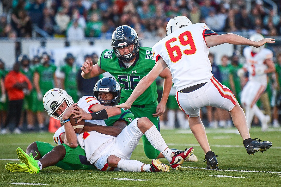 Glacier defensive lineman Kobe Dorcheus (33) sacks Missoula Hellgate quarterback Vince Paffhausen (7) in the first quarter at Legends Stadium on Friday, Sept. 27. (Casey Kreider/Daily Inter Lake)