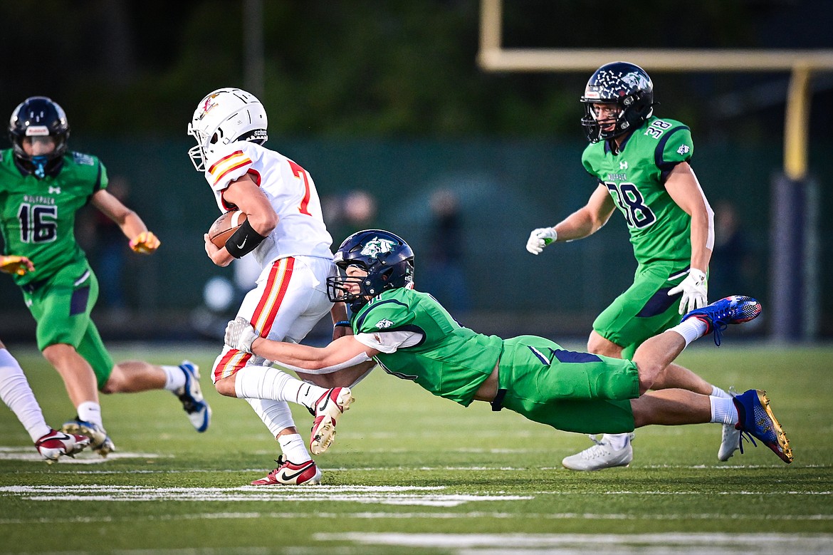 Glacier linebacker Asher Knopik (11) tackles Missoula Hellgate quarterback Vince Paffhausen (7) on a run in the first quarter at Legends Stadium on Friday, Sept. 27. (Casey Kreider/Daily Inter Lake)